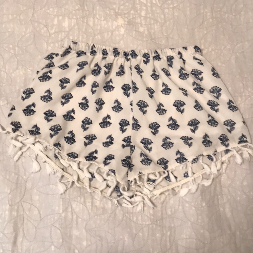 Small frayed blue & white floral print shorts.